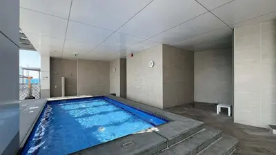 a large swimming pool in a room with at Urban 1BR City view in The Bay Business Bay in Dubai