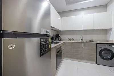 a kitchen with a stainless steel refrigerator and a dishwasher at Urban 1BR City view in The Bay Business Bay in Dubai