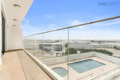 a view from the balcony of a house with a swimming pool at 1BR with Balcony Near Metro Station in Dubai