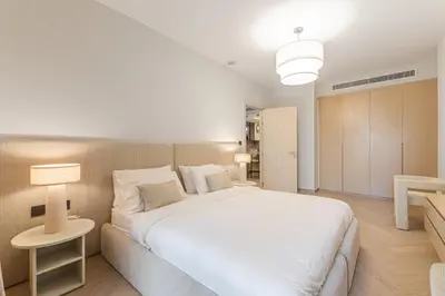 a bedroom with a large white bed and a couch at Cozy Beachside 1-bedroom in Murjan in Dubai