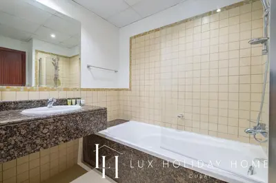 a bathroom with a tub and a sink at LUX The Murjan Sea View Suite 2 in Dubai