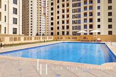 a large swimming pool in front of some buildings at LUX The Murjan Sea View Suite 2 in Dubai