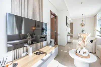 a living room with a large tv on the wall at Sea and City View 1BR, Close to Marina Beach, Botanica Tower, Dubai Marina by Deluxe Holiday Homes in Dubai