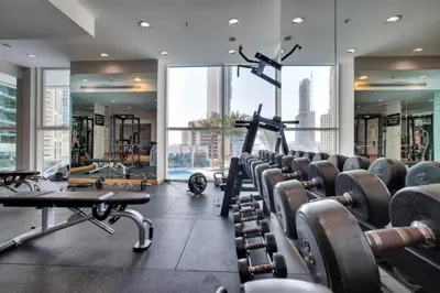 a gym with rows of exercise equipment in a building at Sea and City View 1BR, Close to Marina Beach, Botanica Tower, Dubai Marina by Deluxe Holiday Homes in Dubai