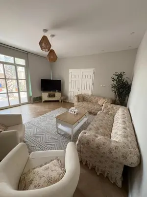a living room with a couch and a table at Barsha South Cozy Guesthouse in Dubai