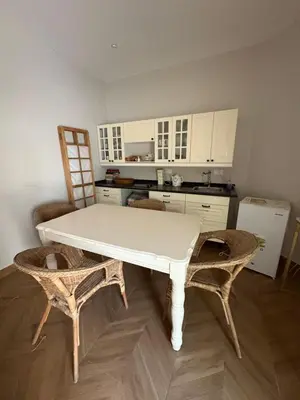 a kitchen with a white table and two chairs at Barsha South Cozy Guesthouse in Dubai