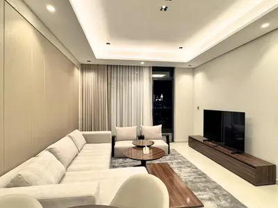a living room with a white couch and a tv at CaiCai Homes 1 BHK Nobles Tower Business Bay 5 min Drive to Dubai Mall in Dubai
