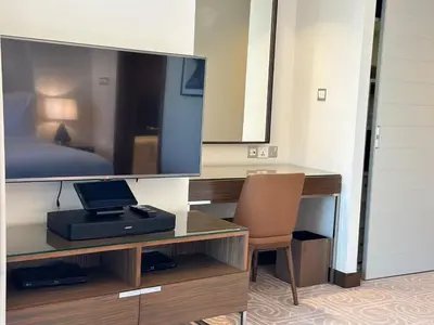 a room with a desk with a television and a chair at Durrani Homes - Dubai Mall Fashion Avenue in Dubai