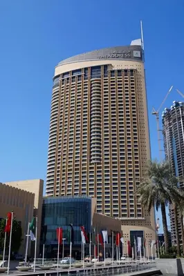 a large building with flags in front of it at Durrani Homes - Dubai Mall Fashion Avenue in Dubai