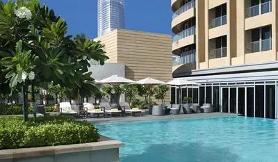 a swimming pool in front of a building at Durrani Homes - Dubai Mall Fashion Avenue in Dubai