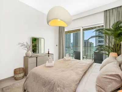 a bedroom with a large bed and a large window at Utra Lux Large 1 BR with Sunset Views and Private Beach in Dubai
