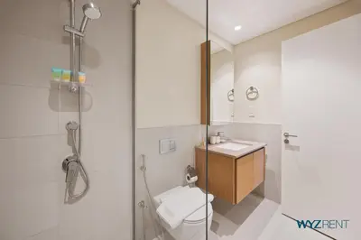 a bathroom with a shower and a toilet and a sink at Pink Panther Soft Glam 1BR in Surf 2-Creek Beach in Dubai