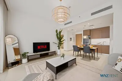 a living room with a table and a kitchen at Serene 1 BR in Surf 2-Creek Beach Access in Dubai