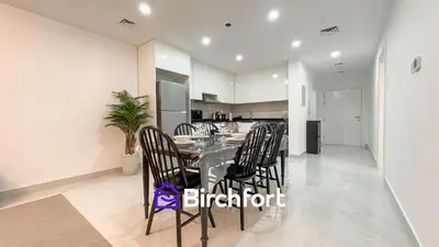 a dining room with a table and chairs in a kitchen at Stylish Stay Steps from the Marina in Dubai
