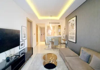 a living room with a couch and a table at Damac Paramount Tower in Dubai
