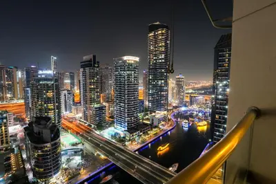 a view of a city skyline at night at Great Flat Near Marina & Beach With Amazing View, Many Activities in Dubai