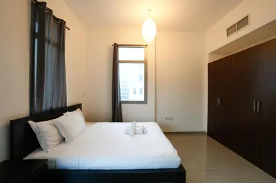 a bedroom with a bed with a teddy bear on it at Great Flat Near Marina & Beach With Amazing View, Many Activities in Dubai