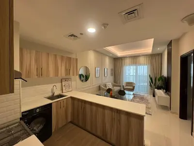 a kitchen with a sink and a dishwasher at Elegant One Bedroom in Sports City in Dubai