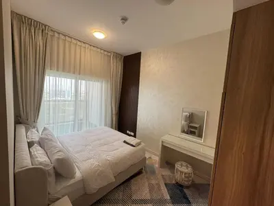 a bedroom with a bed and a window at Elegant One Bedroom in Sports City in Dubai