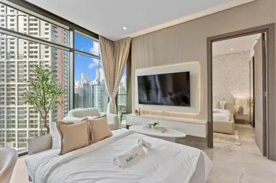 a bedroom with a large bed and a large window at Sleek 1Bedroom with Burj Khalifa view in Peninsula in Dubai