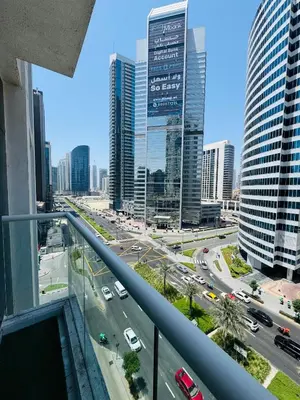 a view of a city with cars on a highway at Maison Prive By DAMAC Studio in Dubai