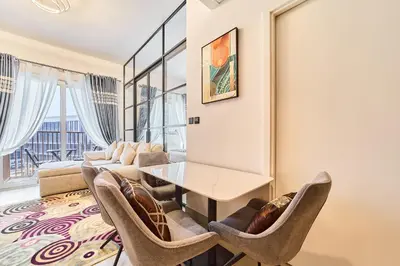 a living room with a table and chairs at Modern 1BR Retreat in Dubai Hills Prime Location in Dubai