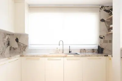a white kitchen with a sink and a window at Villa Zalex Springs 14 Luxury Living with Private Pool in Dubai