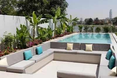 a swimming pool with a couch and a swimming pool at Villa Zalex Springs 14 Luxury Living with Private Pool in Dubai