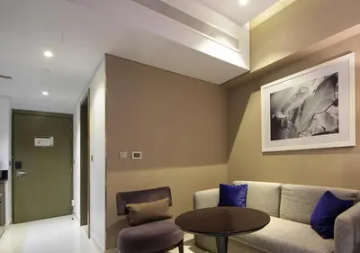 a living room with a couch and a table at Modern Living DAMAC with Balcony & Waterfront Views in Dubai