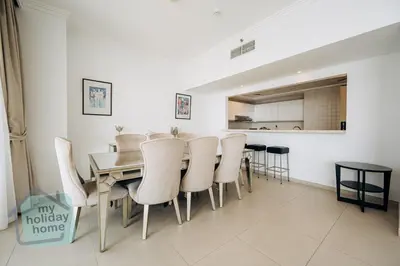 a dining room with a table and chairs at Private Beach - Tourist Spot - High Floor Residence in Dubai