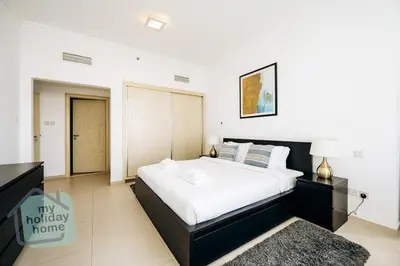 a bedroom with a large bed in a room at Private Beach - Tourist Spot - High Floor Residence in Dubai