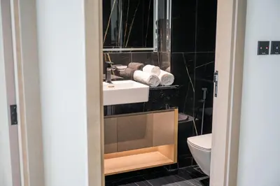a bathroom with a sink and a toilet at Brand New Luxurious - Modern 1BR - Pool - Gym in Dubai