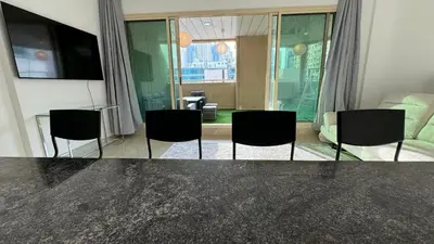 a living room with a table and chairs at 2BHK Garden Apartment at the heart of Dubai Marina in Dubai