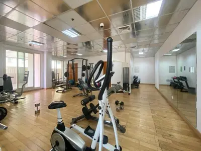 a gym with treadmills and exercise bikes in it at 1 Bedroom in Dubai Marina opp Dmcc metro station in Dubai