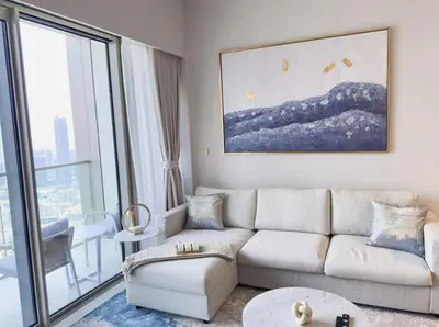 a living room with a couch and a large window at GRANDE SIGNATURE with a direct Burj Khalifa view and Private Fountain Show at high floor with DXB AIRPORT VIP Shuttle option for 6 guests in Dubai