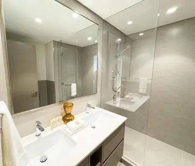 a bathroom with a sink and a shower and a mirror at GRANDE SIGNATURE with a direct Burj Khalifa view and Private Fountain Show at high floor with DXB AIRPORT VIP Shuttle option for 6 guests in Dubai