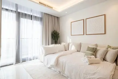 a white couch in a room with a large window at 3BR in Paramount with Panoramic Infinity Pool in Dubai