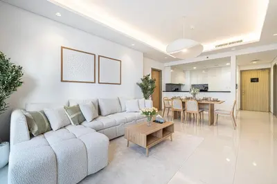 a living room with a couch and a table at 3BR in Paramount with Panoramic Infinity Pool in Dubai