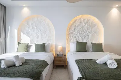 two beds sitting next to each other in a bedroom at 3BR in Paramount with Panoramic Infinity Pool in Dubai