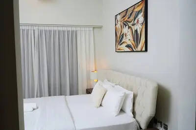 a bedroom with a white bed with white pillows at 2BR Apartment In Dubai in JVC near Circle mall in Dubai