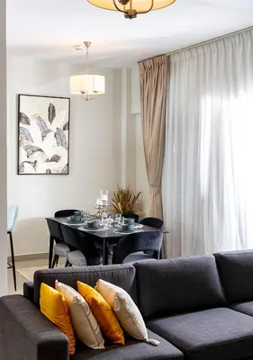 a living room with a couch and a table at 2BR Apartment In Dubai in JVC near Circle mall in Dubai
