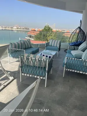 a group of chairs and a table on a balcony at Fleur Star Apartments in Dubai