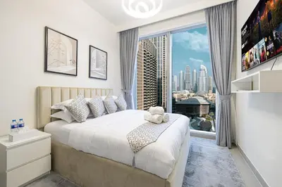 a bedroom with a bed and a large window at Stay in Modern Elegance 4BR with Pool Gym and Boulevard Views in Dubai