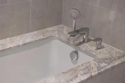 a sink in a bathroom with a faucet at Stay in Modern Elegance 4BR with Pool Gym and Boulevard Views in Dubai