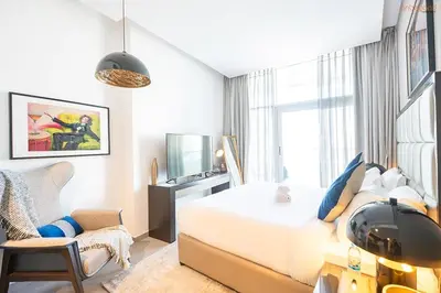a bedroom with a bed with a helmet on it at Bnbeyond's Artsy Canal-View Studio in the Heart of BBay in Dubai