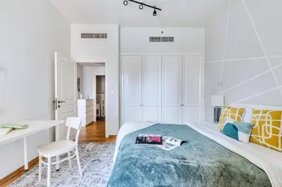 a bedroom with a bed and a desk and a chair at The Smart Concierge - Rimal 4 in Dubai
