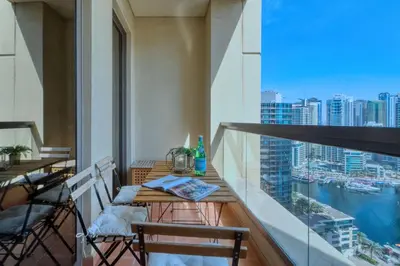 a balcony with a table and chairs and a view of the city at The Smart Concierge - Rimal 4 in Dubai