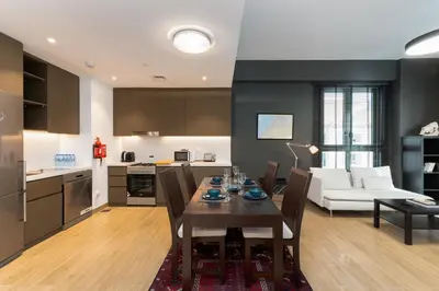 a kitchen and living room with a table and a couch at La Sirene 1, Port De La Mer - Mint Stay in Dubai