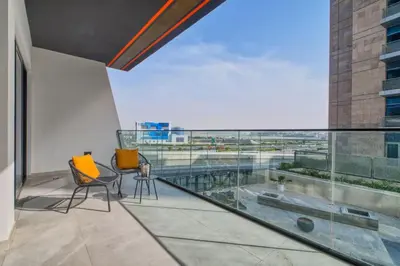 an apartment balcony with a view of an airport at The Smart Concierge - Binghatti Canal in Dubai