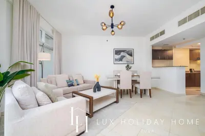 a living room with a couch and a table at LUX The Dubai Marina View Suite 2 in Dubai